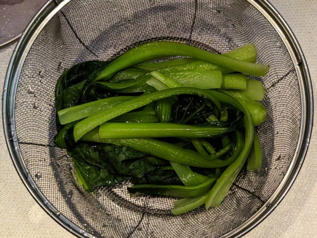 茹で上がった小松菜をザルに上げ粗熱を取る