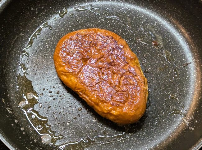 フライパンでクリームパンのフレンチトーストを両面こんがり焼いている様子